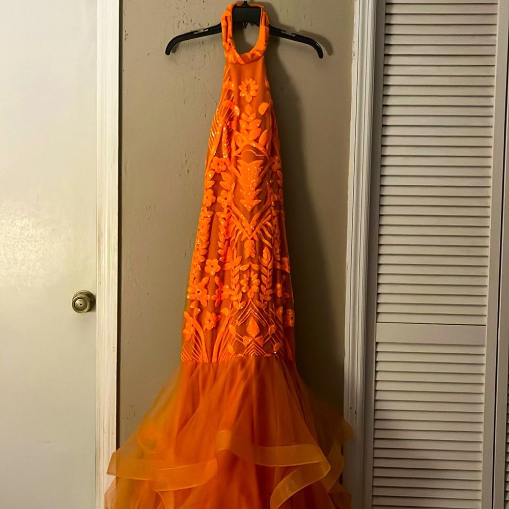Selling an orange mermaid prom dress, size 4, wore one time in great condition.